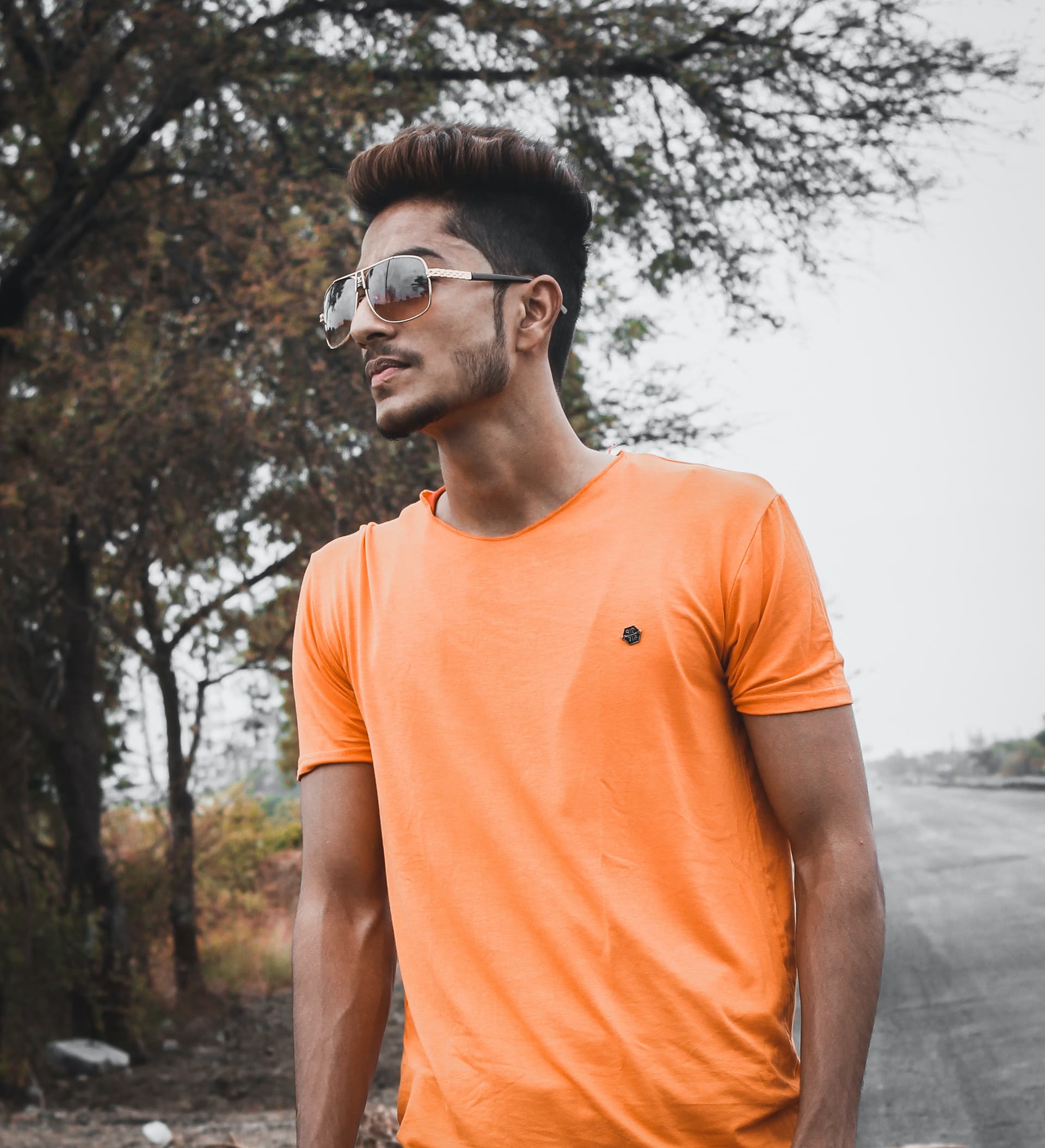 man-standing-while-wearing-orange-crew-neck-shirt-near-tree-1392045.jpg